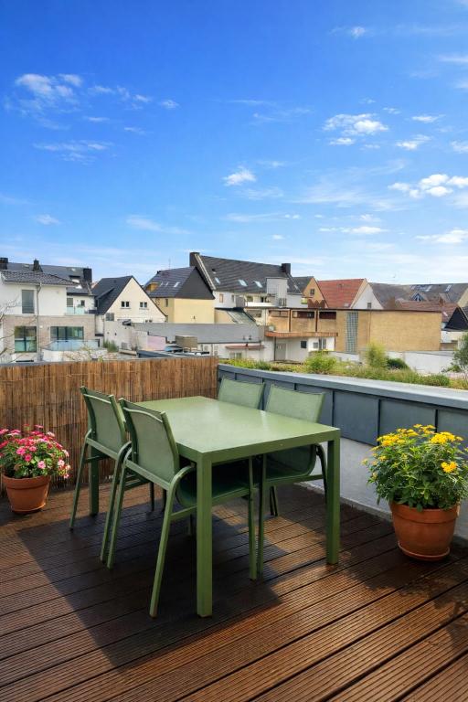 a green table and chairs sitting on a deck at Altstadt Apartment Deluxe 3 in Haltern