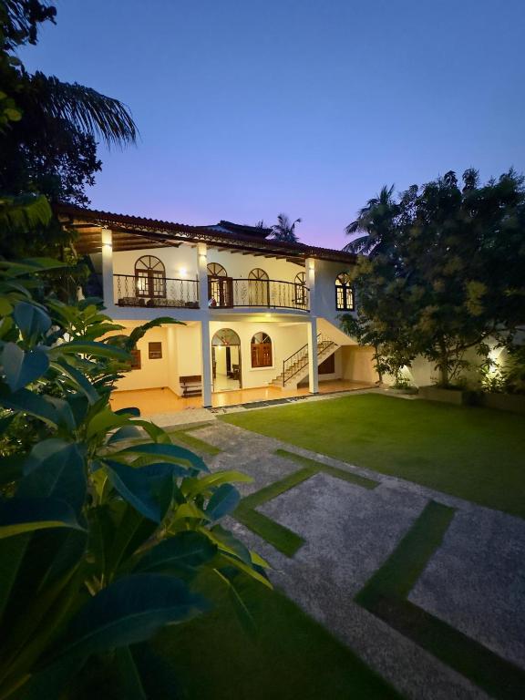 an exterior view of a house at night at THC - Tropical Hideaway Ceylon in Talpe