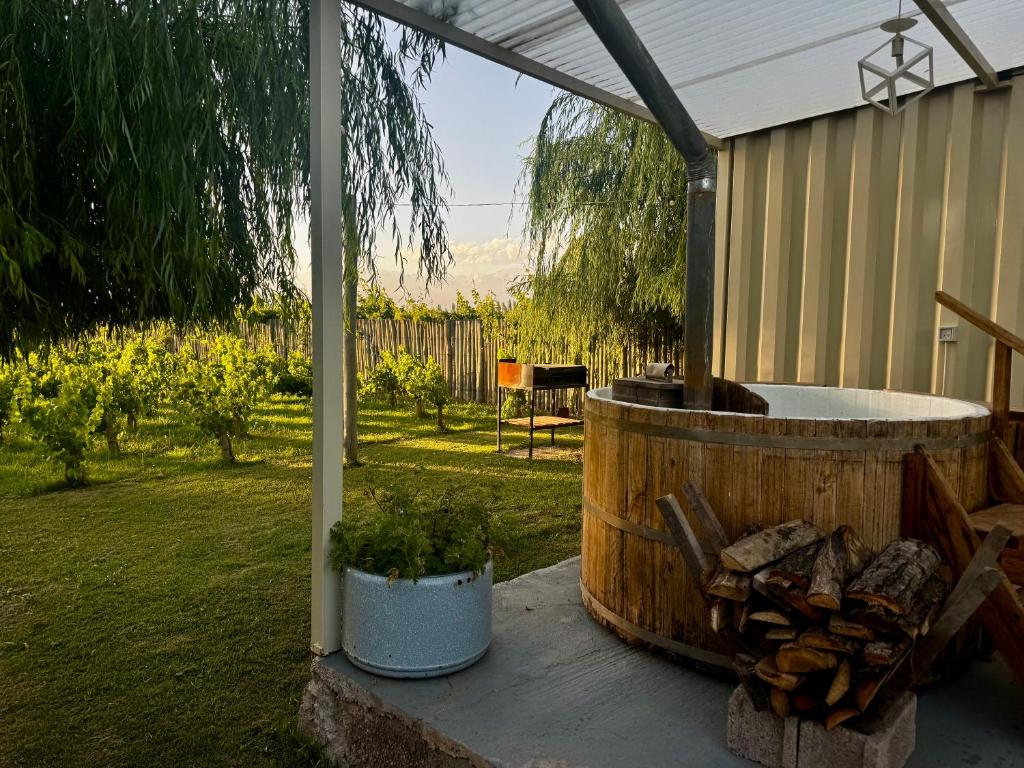 a hot tub sitting under a tent in a yard at KooColand- Container con jacuzzi privado in Tupungato