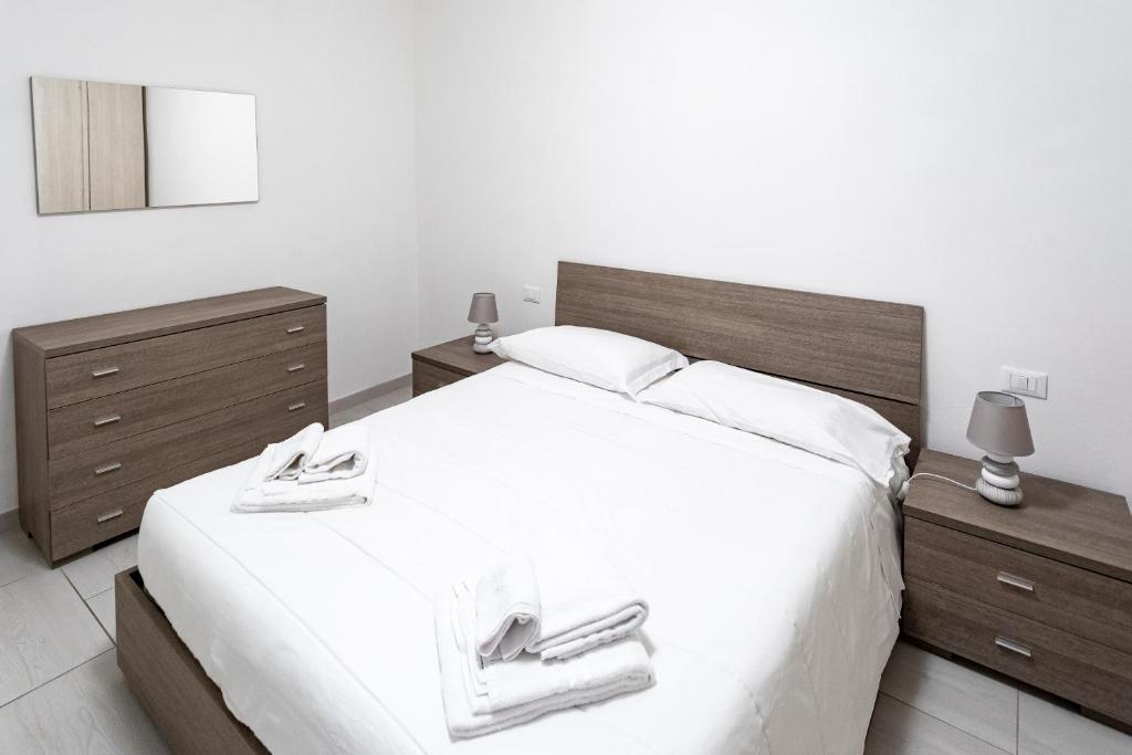 a bedroom with a large white bed with two night stands at Casa Cesari in Ponte Ronca