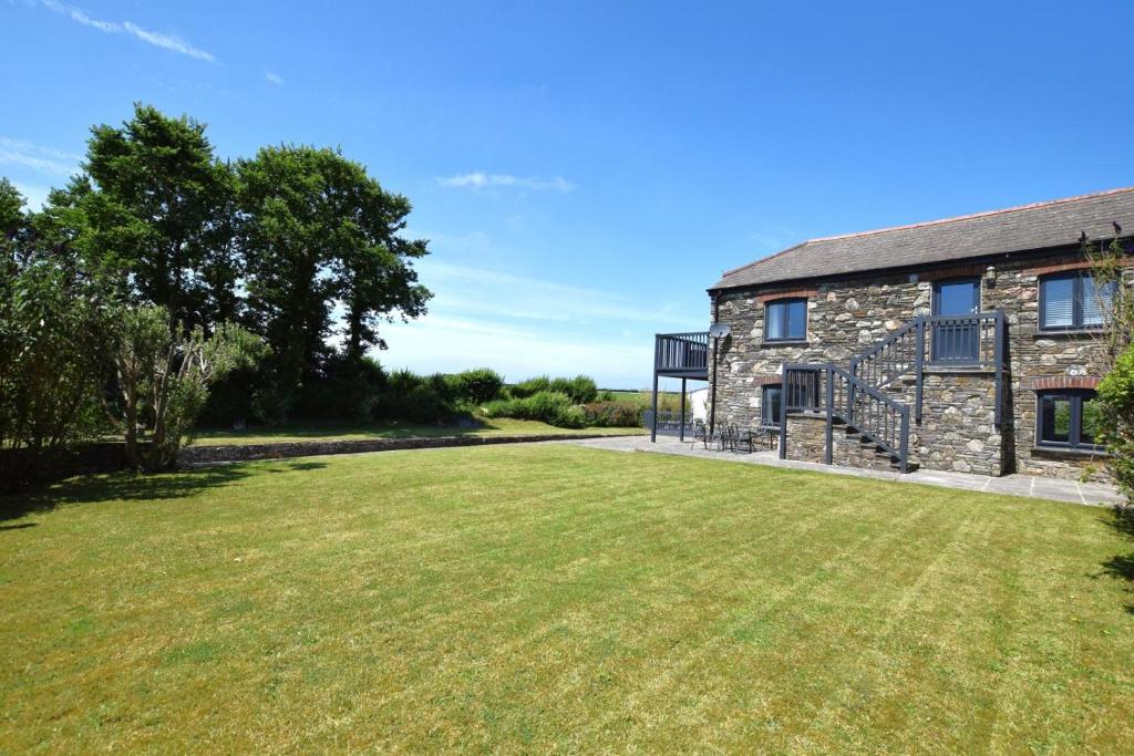 a stone house with a large lawn in front of it at 2 Bed in St. Minver oc-r29475 in Saint Minver
