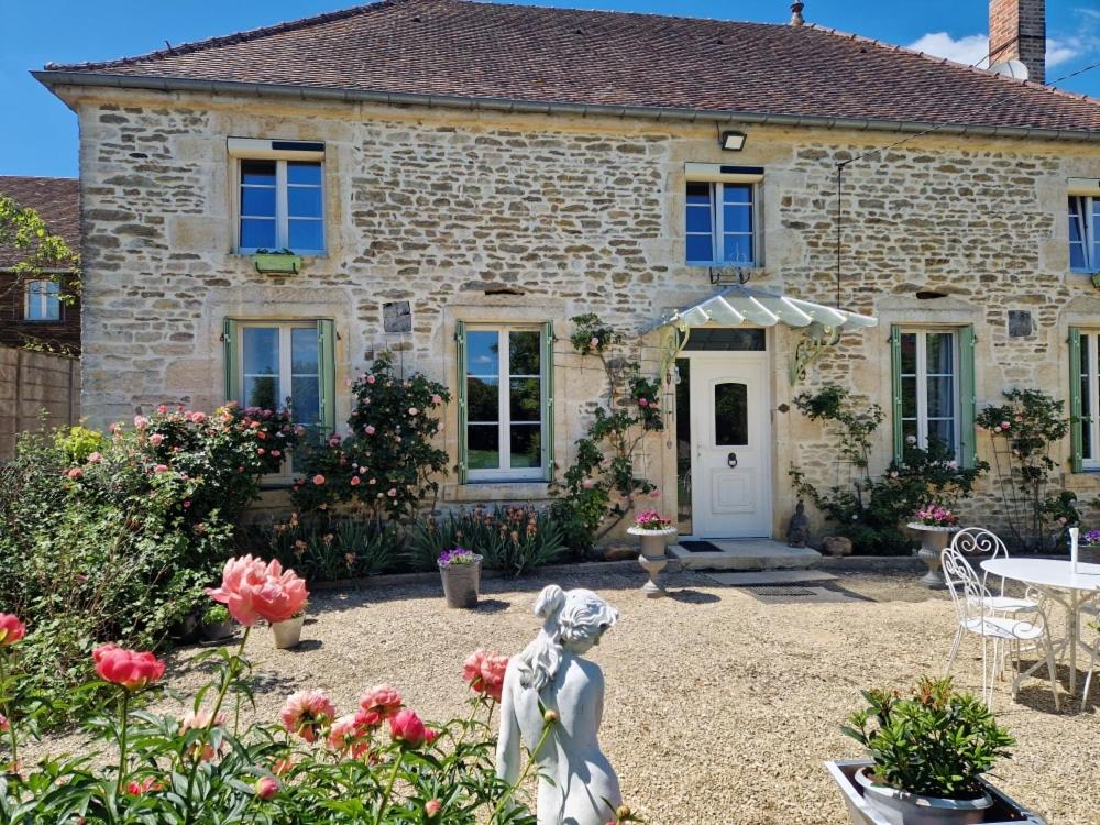a stone house with a statue in front of it at CHARM & FOLIe in Praslin