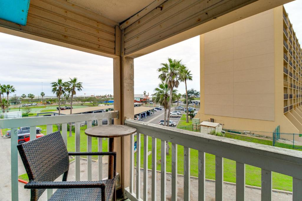 a balcony with a table and chairs and a view of a street at Steps to North Beach: Gem w/ Ocean-View Balcony! in Corpus Christi
