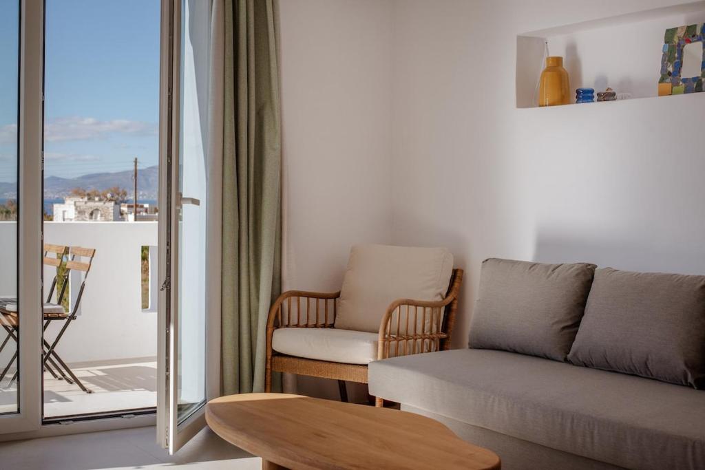 a living room with a couch and a chair at Aelia Kastraki Beach House in Kastraki