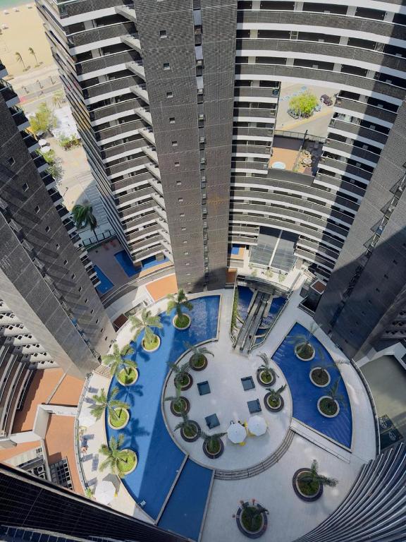 an overhead view of a building with a pool and buildings at Apart 203 Vista Mar in Fortaleza