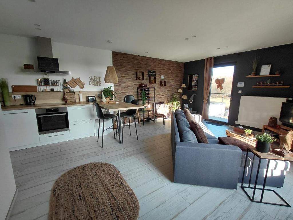 a living room with a couch and a table and a kitchen at Sweet Dreams in Visé