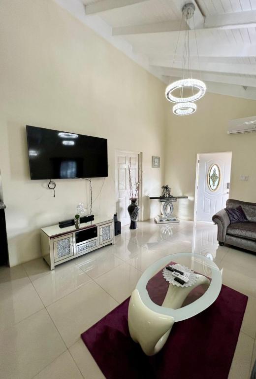 a living room with a couch and a table at Trinity Villa in Ocho Rios