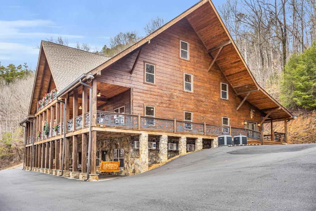 a large wooden house with a gambrel roof at Tellico River Retreat in Tellico Plains