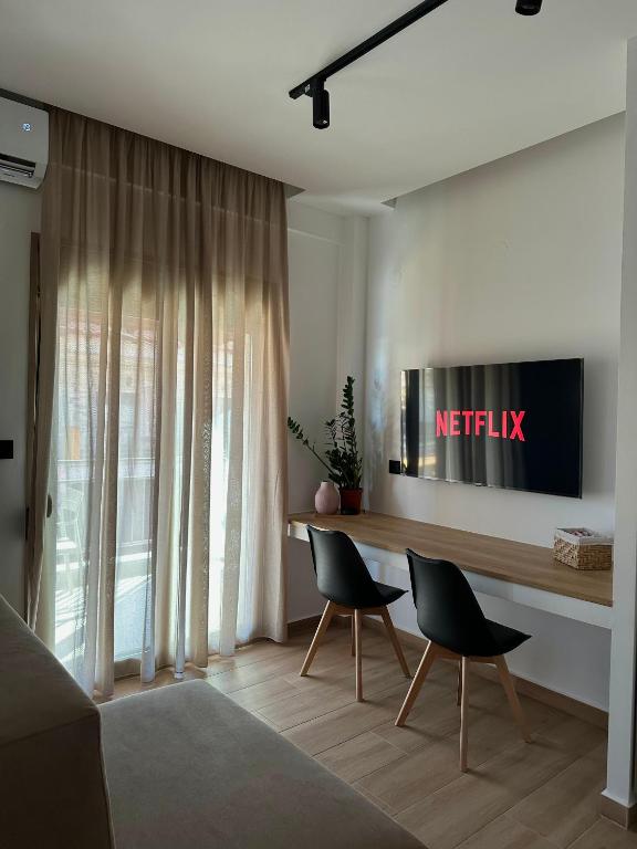 a living room with a table and two chairs at Nido Estivo 1 in Nea Skioni