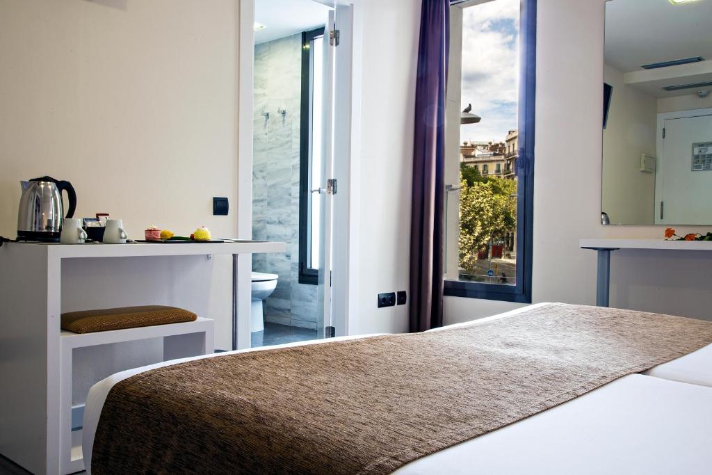 Postel nebo postele na pokoji v ubytování BCN Urbaness Hotels Del Comte