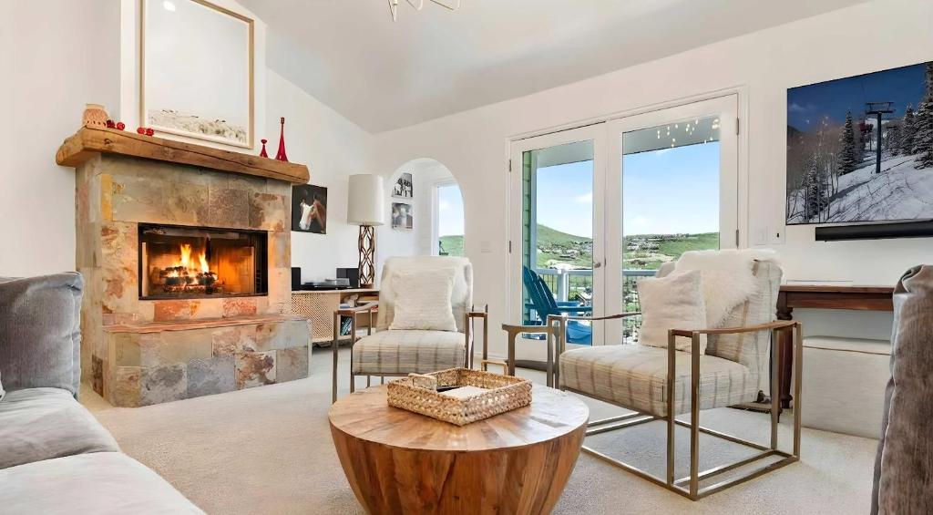 a living room with a fireplace and a table at Summit Home Multi-level with PC Views Ski Trail in Park City