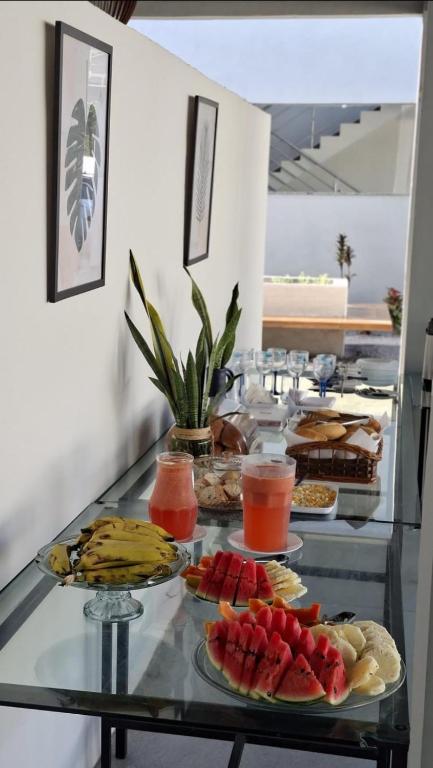 a buffet with many plates of food on a table at Asas da Maré Pousada in Bragança