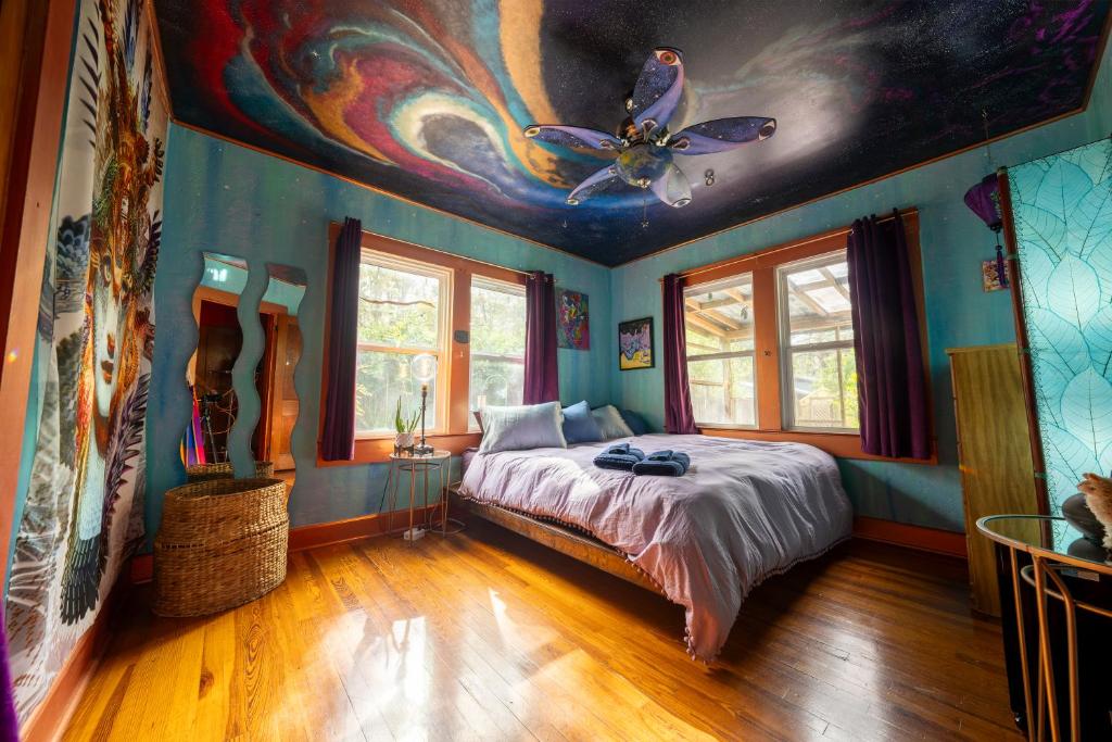 a bedroom with a bed with a butterfly painted on the ceiling at Creatives Retreat for Artists & Lovers in Gainesville