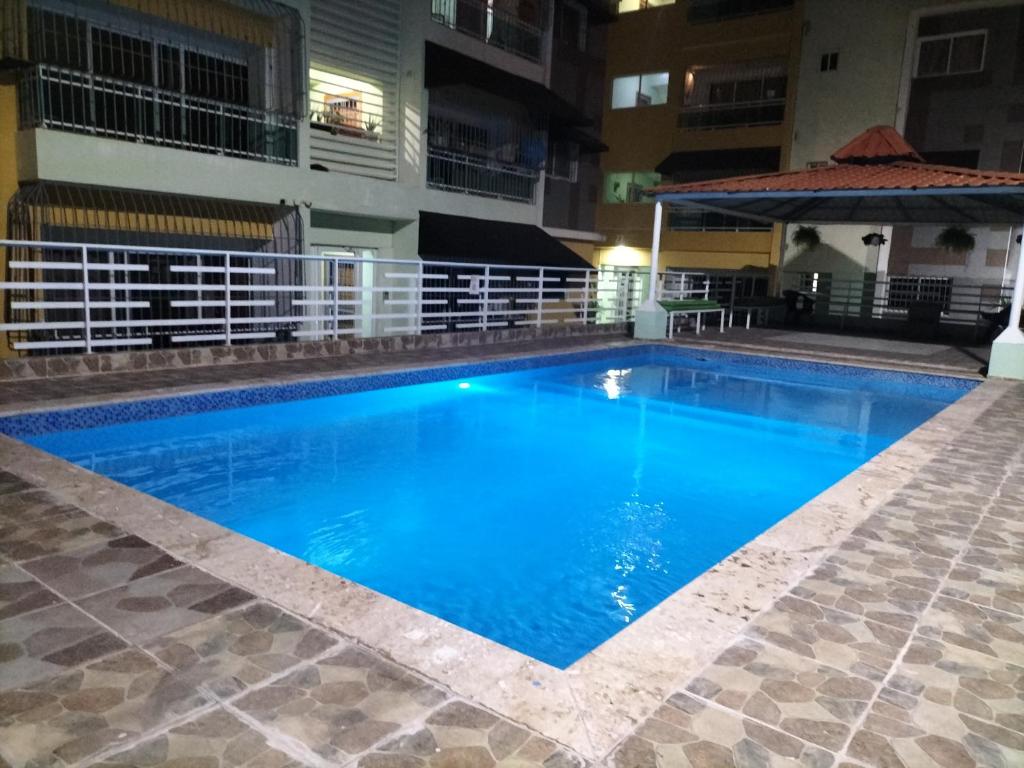 a swimming pool in the middle of a building at Areito Apartament A&A in Juan López
