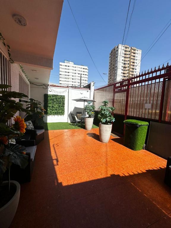 a balcony with three potted plants on a building at Éclat Hotel Boutique in Iquique