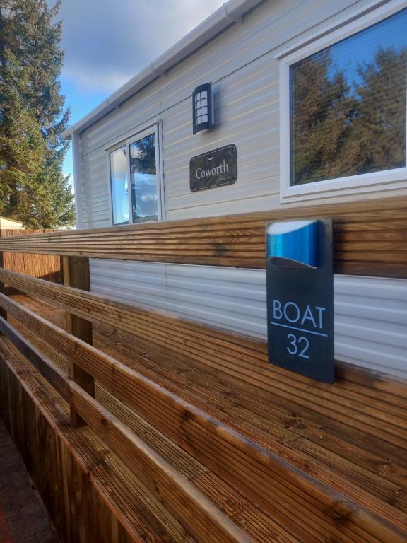 a house with a sign on a fence at Boat 32 in Boat of Garten