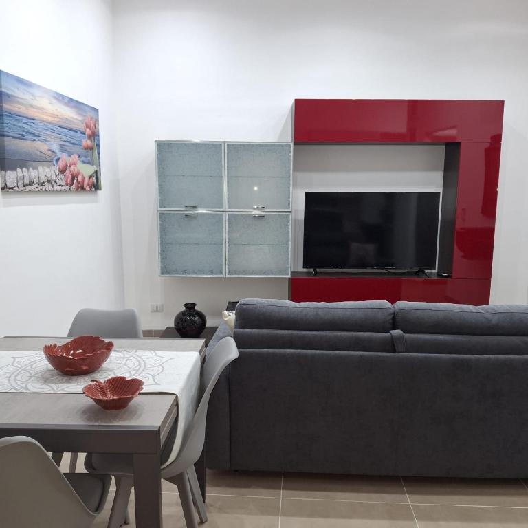 a living room with a couch and a tv at Casa Bruno in Palermo
