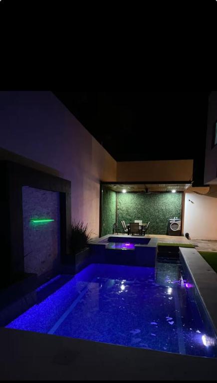 a house with a swimming pool at night at Casa Chonita in Tecuala