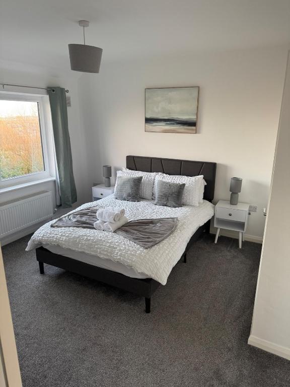 a bedroom with a bed and a window at Rowe Terrace Workington in Workington