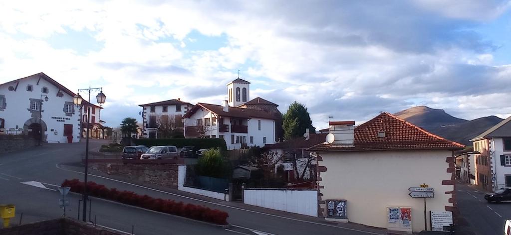 a view of a town with houses and a church at Compostelle Chemin Garazi in Uhart-Cize