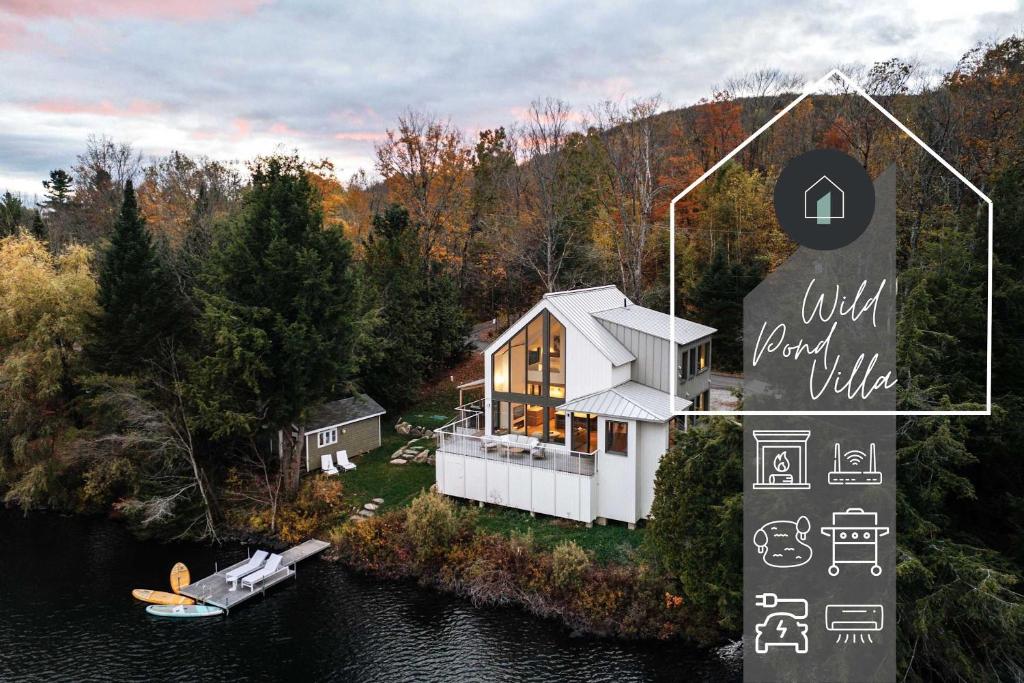 an aerial view of a house on a lake at Wild Pond Villa in Mansonville