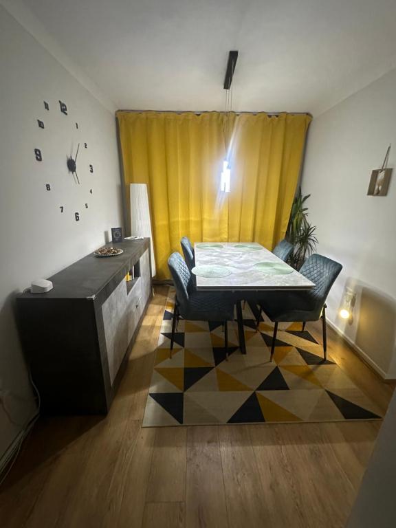 a dining room with a table and a yellow curtain at Newport by M4 in Newport
