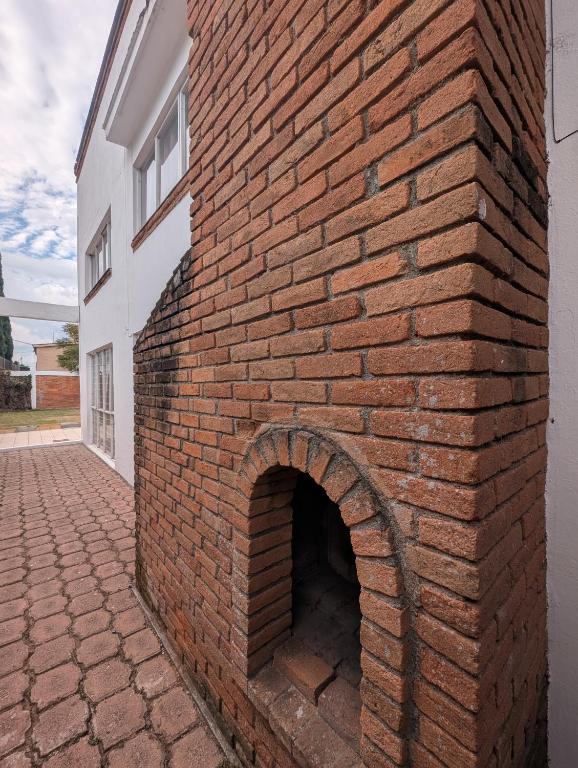 a brick wall with a brick oven on the side of a building at Casa Amari - Para 17 Personas - Grupos y Eventos in Morelia