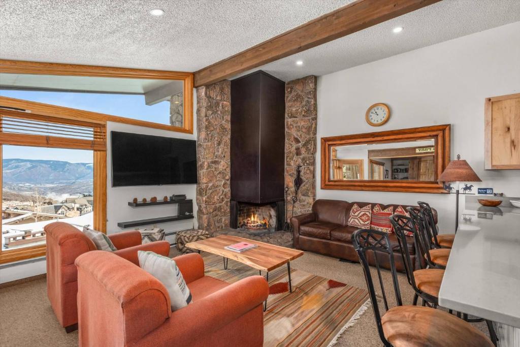 a living room with a couch and a fireplace at Shadowbrook 303 in Snowmass Village
