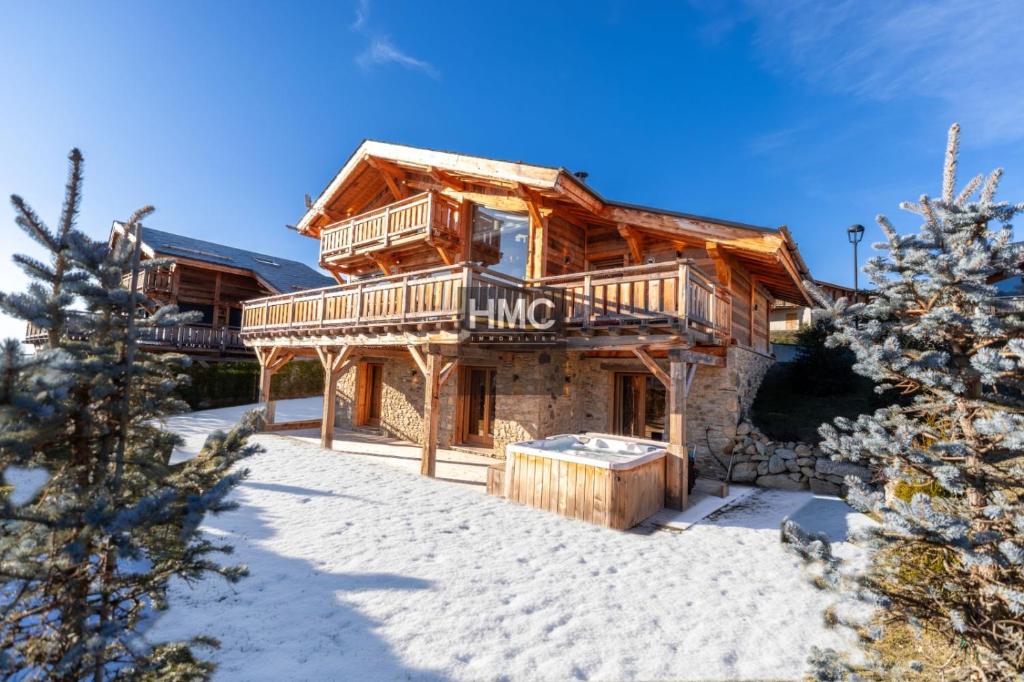 a log cabin in the snow with a sign that reads hino at Bliss luxe pyrénéen jacuzzi et vue montagne in Bolquere Pyrenees 2000