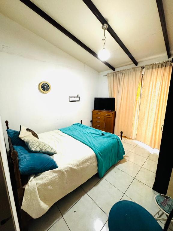 a bedroom with a bed and a tv in it at Pieza cama doble in Arica