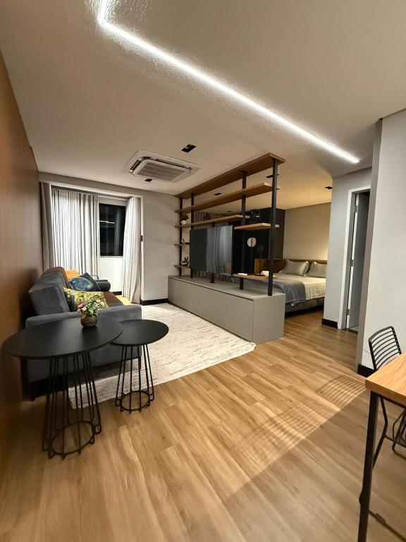 a living room with a couch and a bed at Studio Aconchegante no Number One Flat com vista mar in São Luís