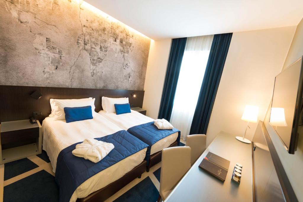Ліжко або ліжка в номері Hotel Manin