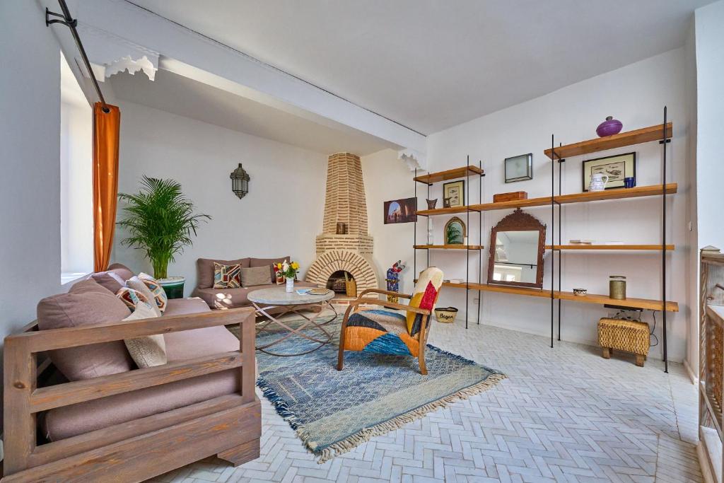a living room with a couch and a table at La Douiria Essaouira Medina in Essaouira