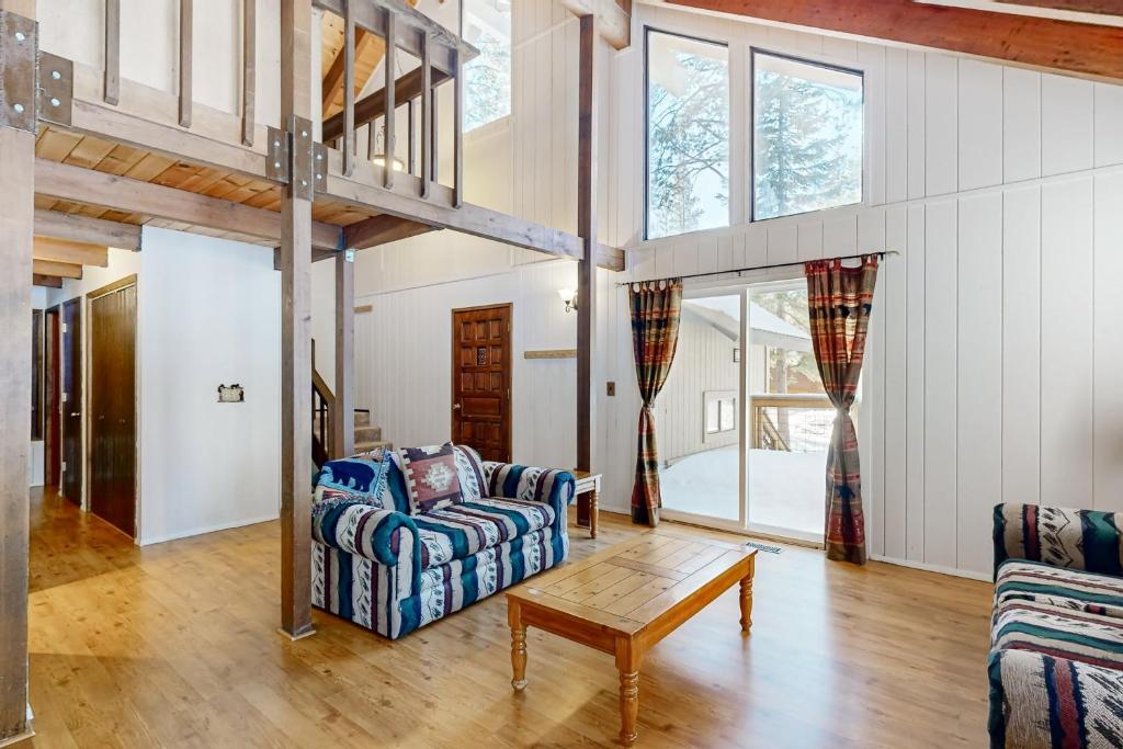 a living room with a couch and a table at < 2 Mi to Tahoe Donner Ski Resort: Serene Retreat in Armstrong