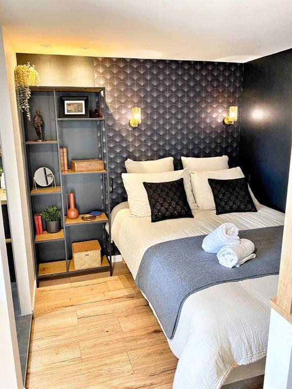a bedroom with two beds in a room at Le Repères des sommeliers - Bail Partner in Auxerre