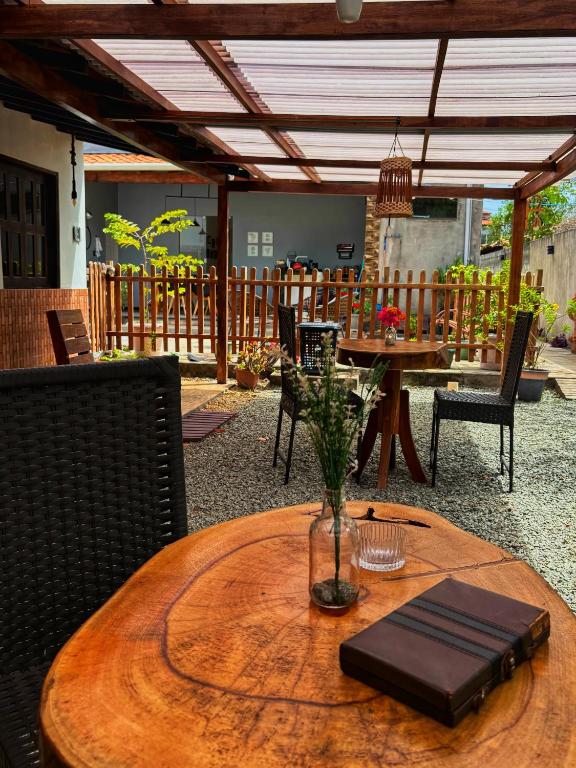 a wooden table with a vase on top of it at Espaço Augusto in Barreirinhas