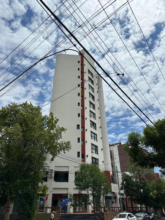 a tall white building with power lines in front of it at Los Recoletos in Villa Mercedes