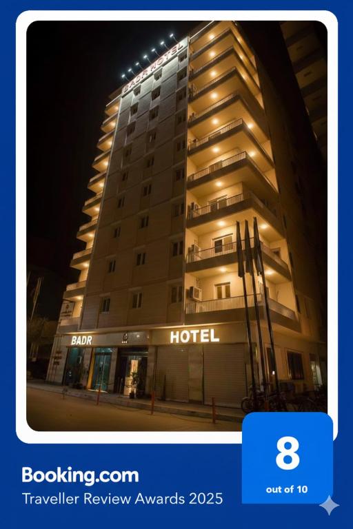 a building with a hotel sign on the side of it at Badr Hotel Assiut in Asyut