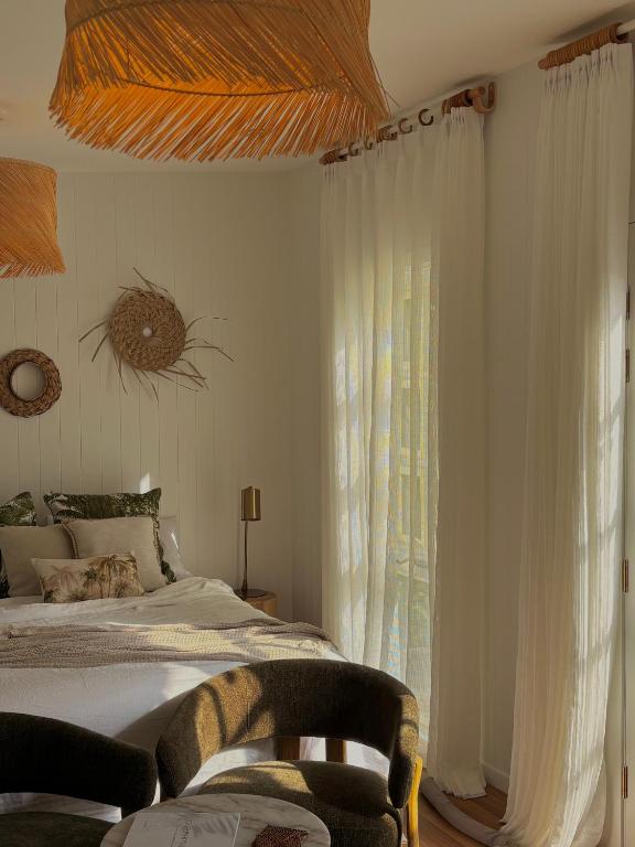 a bedroom with a bed and a large window at Moana bungalow in Hideaway Bay