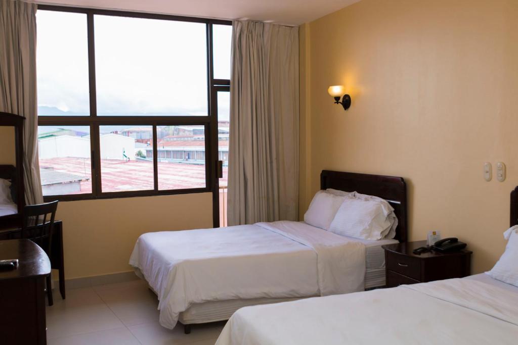 Postel nebo postele na pokoji v ubytování Hotel Novo