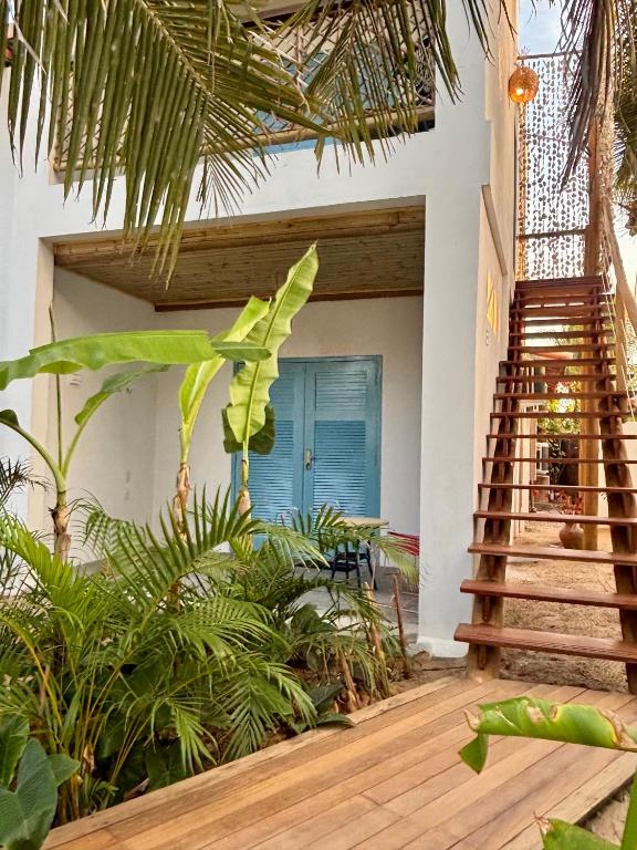 a staircase leading to a house with plants at Pousada Buji in Maracajaú