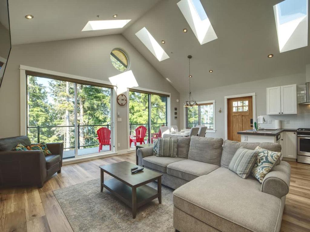 a living room with a couch and a table at Oceanfront & Amazing Views - Pet Friendly - 2bdrm in Port Renfrew
