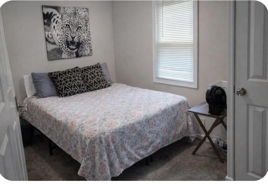 a bedroom with a bed and a picture of a tiger at Cozy Small Private Room 3 on McDaniel Street in Atlanta