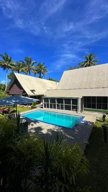 a swimming pool in front of a building at Villa Serenity welcomes you in Pacific Harbour