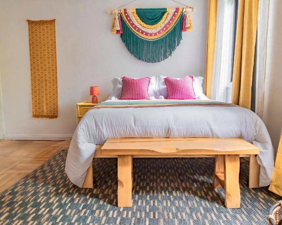 a bedroom with a bed with pink pillows at Lofts Álvaro Obregón in Mexico City