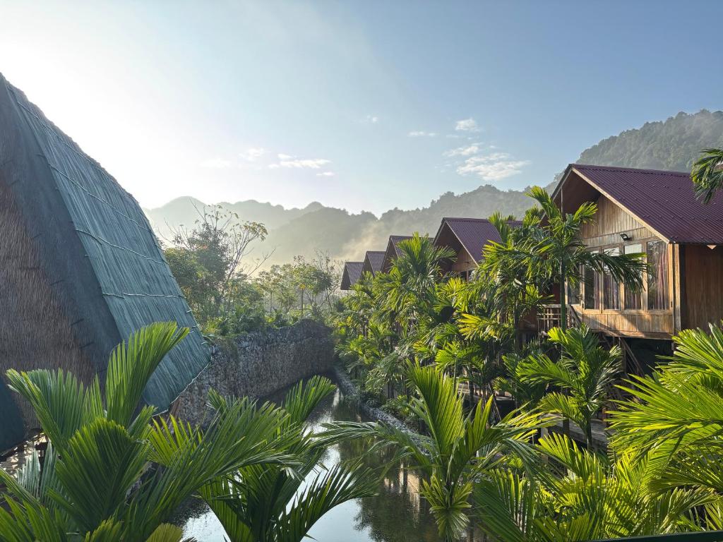 a view of a resort with mountains in the background at Phong Nha Mountain House in Vực Trô