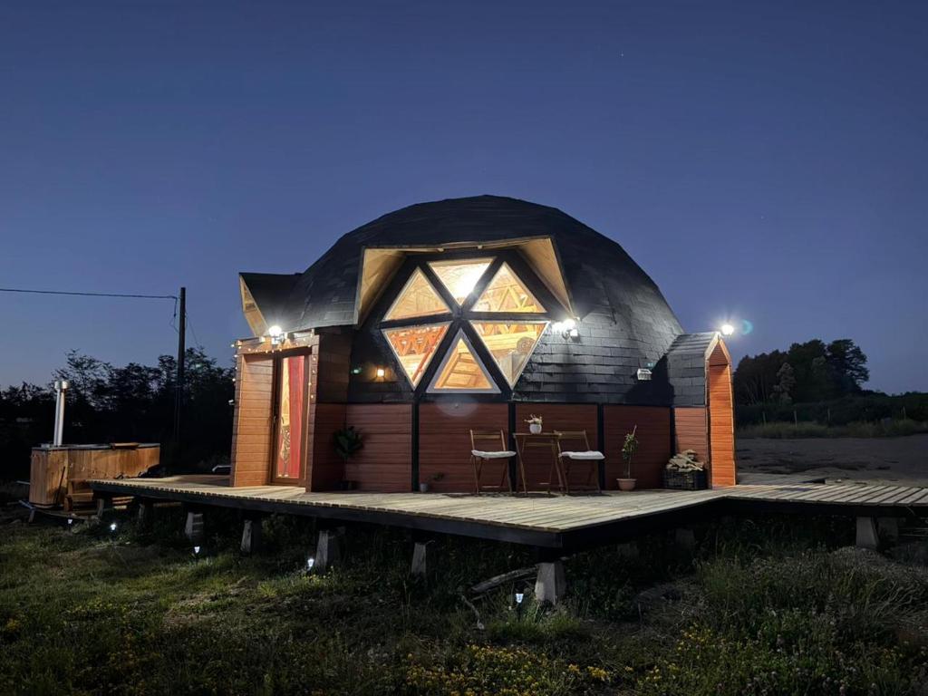 a dome house with a deck in a field at Domo loft puacura - tinaja disponible in Castro