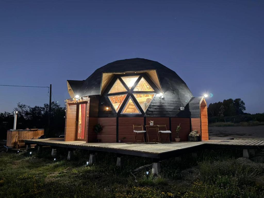 an igloo house with a deck and lights on it at Cabaña Dalcahue Avenida Mocopulli in Dalcahue