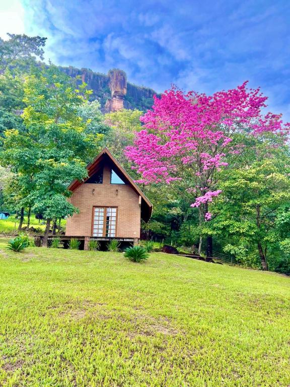 a small house in a field with trees at Cabana na Mata Paraíso da Serra in Aquidauana