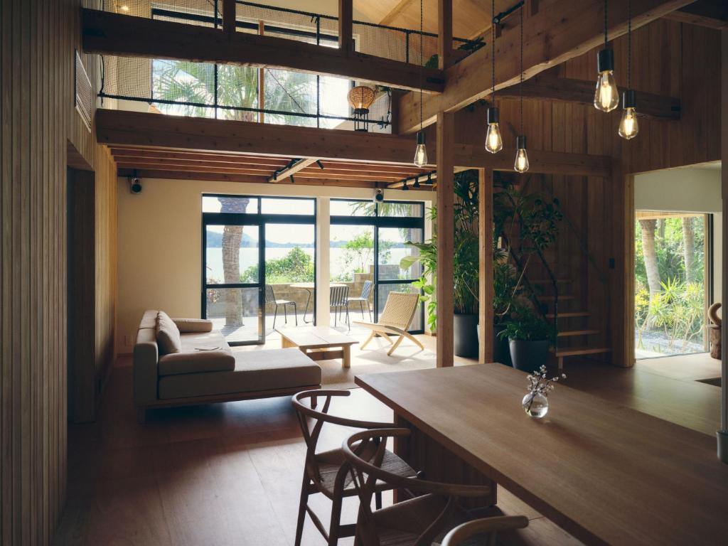 a living room with a couch and a table at SANU 2nd Home MON Amami Oshima in Tatsugo